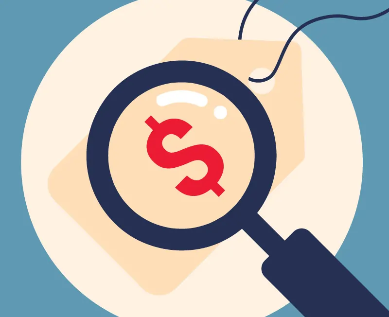 Lupa enfocando un signo de dólar sobre una etiqueta de precio.